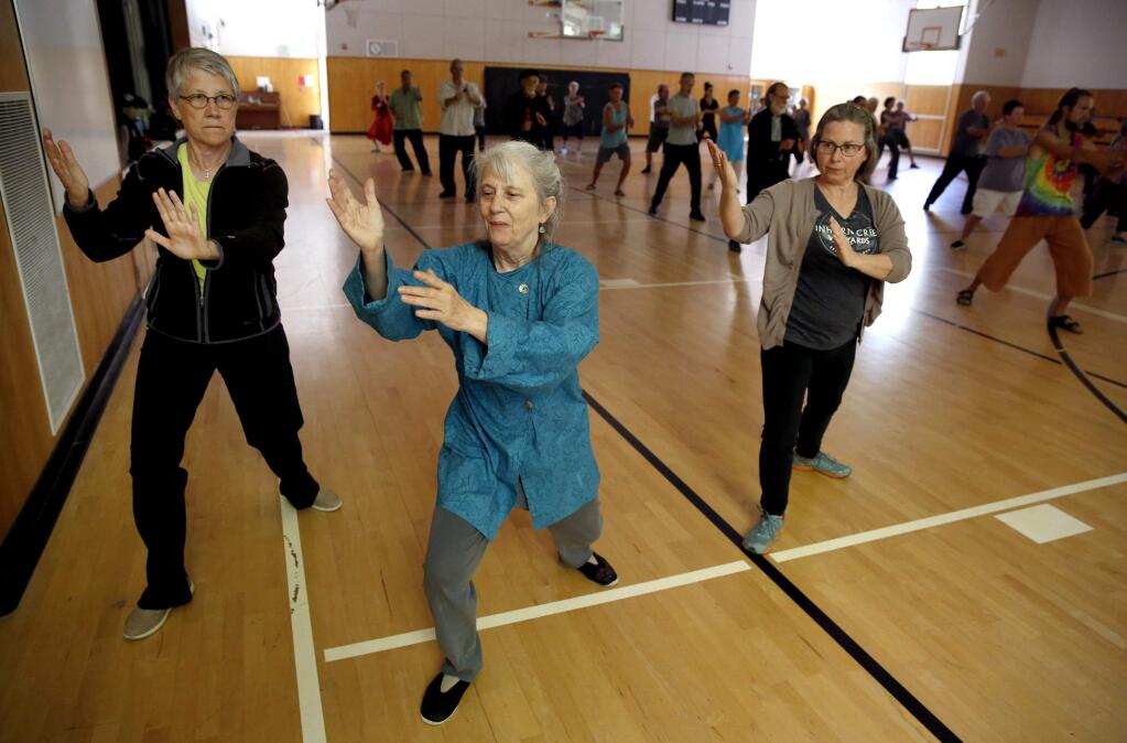 Beth SCHLANKER / The Press Democrat)Jane Golden, who has been teaching taichi for 30 years, works works with students Susan Wood, left, and Marcy Jordan at Salmon Creek School in Occidental.