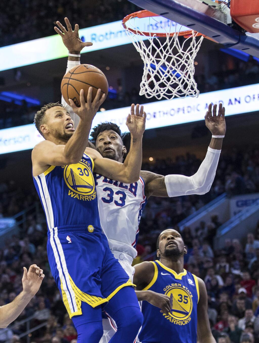 Golden State Warriors' Stephen Curry, left, goes up for the shot with Philadelphia 76ers' Robert Covington, right, defending during the first half of an NBA basketball game Saturday, Nov. 18, 2017, in Philadelphia. (AP Photo/Chris Szagola)