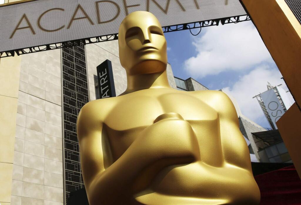 FILE - In this Feb. 21, 2015 file photo, an Oscar statue appears outside the Dolby Theatre for the 87th Academy Awards in Los Angeles. The organization that bestows the Academy Awards says it is suspending plans to award a new Oscar for popular films amid widespread backlash to the idea. The Academy of Motion Picture Arts and Sciences says Thursday that it will study plans for the category further. (Photo by Matt Sayles/Invision/AP, File)
