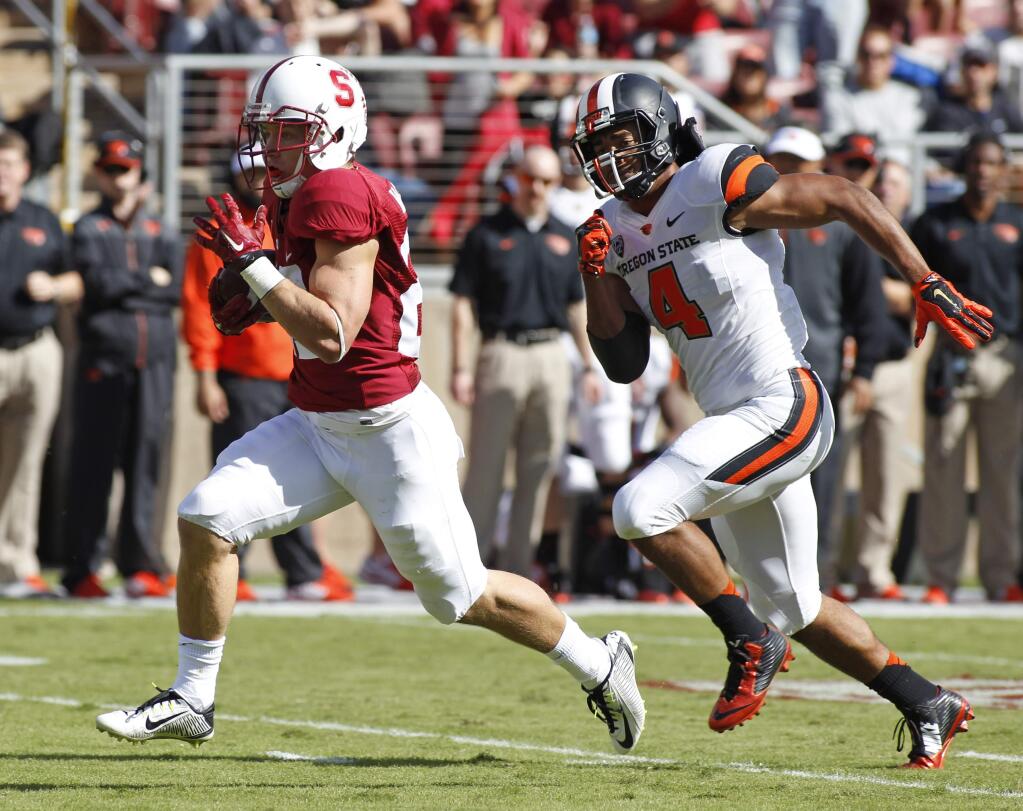 Stanford's Christian McCaffrey runs for a touchdown as Oregon State's D.J. Alexander chases during the first half of a game, Saturday, Oct. 25, 2014, in Stanford. (AP Photo/George Nikitin)