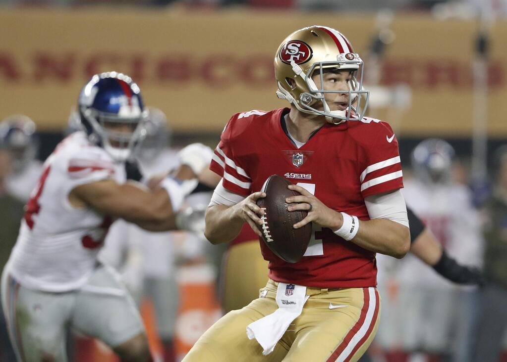 FILE - In this Nov. 12, 2018, file photo, San Francisco 49ers quarterback Nick Mullens looks for a receiver during the second half against the New York Giants in Santa Clara. (AP Photo/Tony Avelar, File)