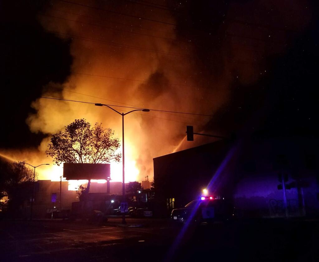 Flames and smoke rise from a fire at an apartment complex under construction in Oakland, Calif., early Tuesday, Oct. 23, 2018. (Will Tran/KRON4 News via AP)