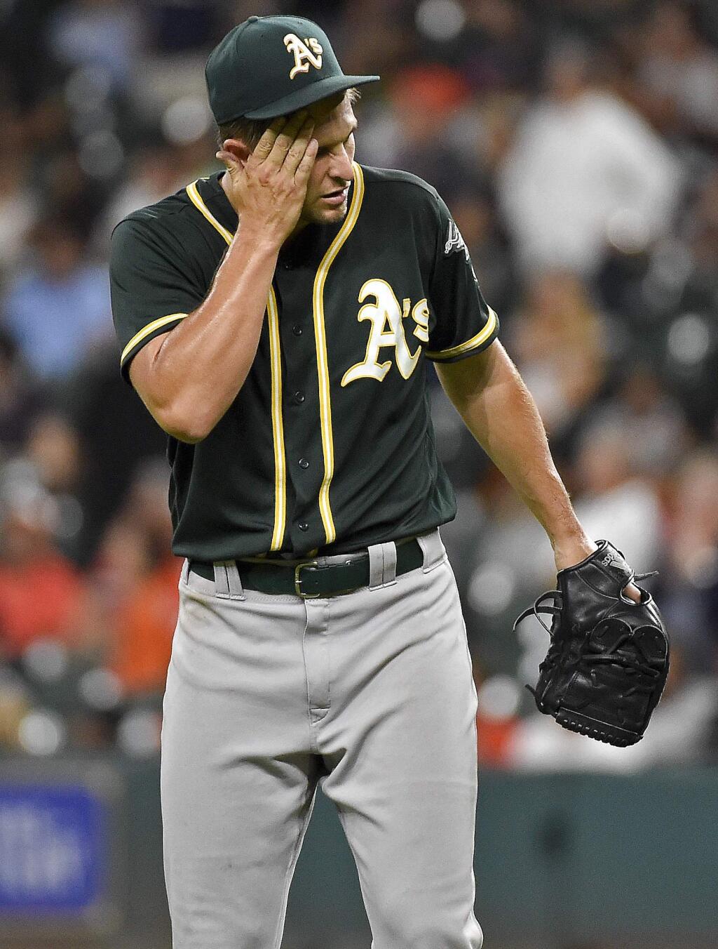 Oakland Athletics starting pitcher Kendall Graveman reacts after giving up a solo home run to Houston Astros' Evan Gattis during the seventh inning of a baseball game Tuesday, Aug. 30, 2016, in Houston. (AP Photo/Eric Christian Smith)