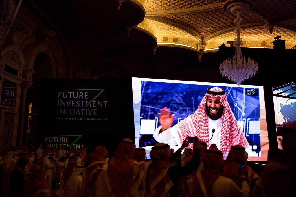 Crown Prince Mohammed bin Salman of Saudi Arabia is pictured on a video monitor as he speaks on Wednesday, the second day of the Future Investment Initiative conference in Riyadh, Saudi Arabia. (TASNEEM ALSULTAN / New York Times)