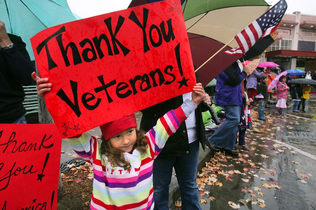 Sadie Jones, 5, of Santa Rosa braved the rain and joined the large crowd for the Petaluma Veteran's Day Parade on Friday, November 11, 2011.