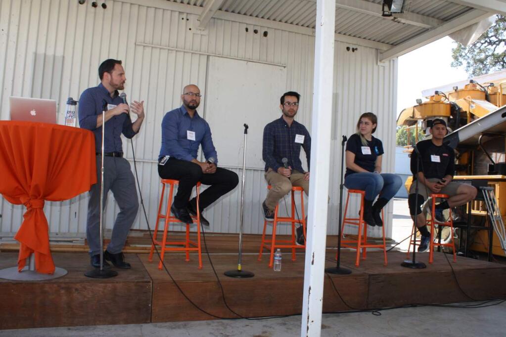 Four panelists discussed how and why they became involved in the manufacturing industry for more than 90 students at 180 Studios in Santa Rosa during the second annual Sonoma County Manufacturing Day on Oct. 19, 2018. Panelists are, from left, Juan Alvarez of Viavi Solutions, Sean Winchester of Endologix, Megan Dellavalle of Medtronic and Ian Serrano of Straus Family Creamery. The panel is moderated by Brandon Jewell of CTE Foundation Sonoma County. (GARY QUACKENBUSH / FOR NORTH BAY BUSINESS JOURNAL)