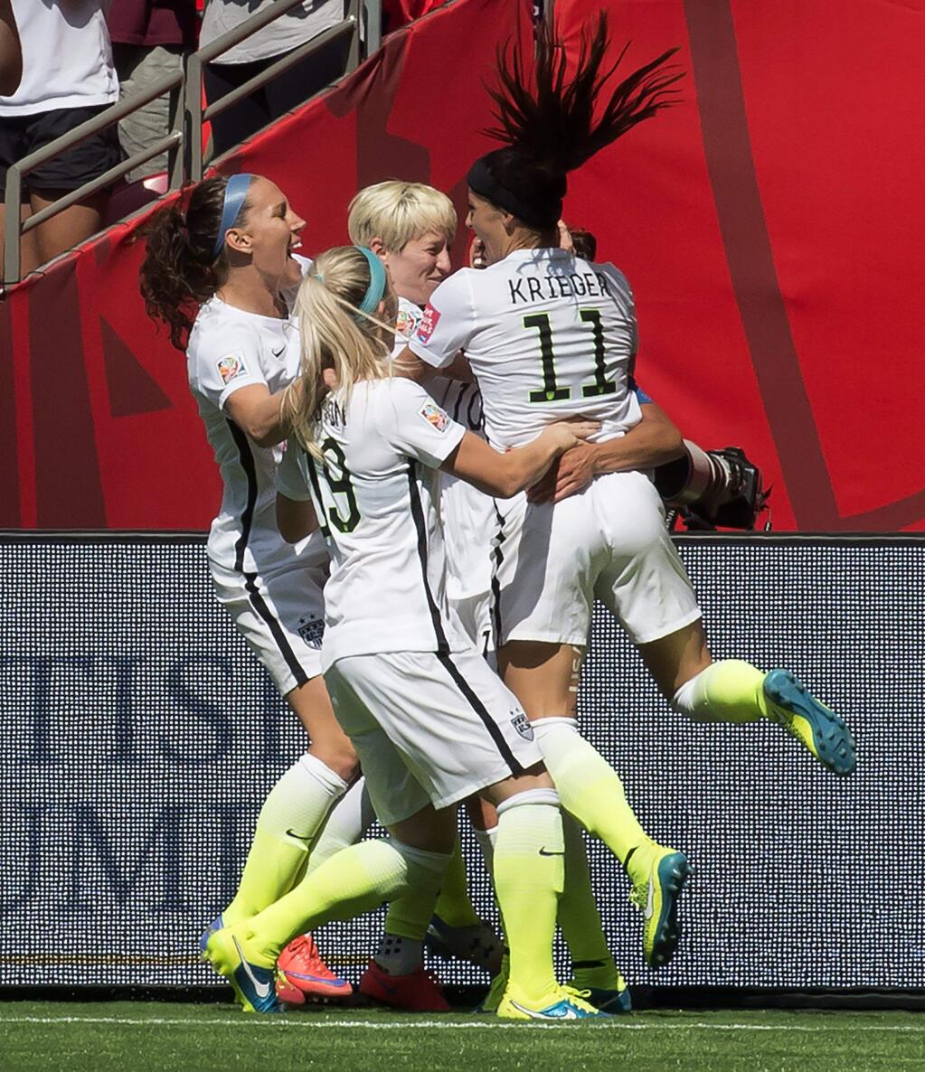 The United States team celebrates Carli Lloyd's goal during the first half of the FIFA World Cup soccer championship against Japan in Vancouver, British Columbia, Canada, Sunday, July 5, 2015. (Jonathan Hayward/The Canadian Press via AP) MANDATORY CREDIT