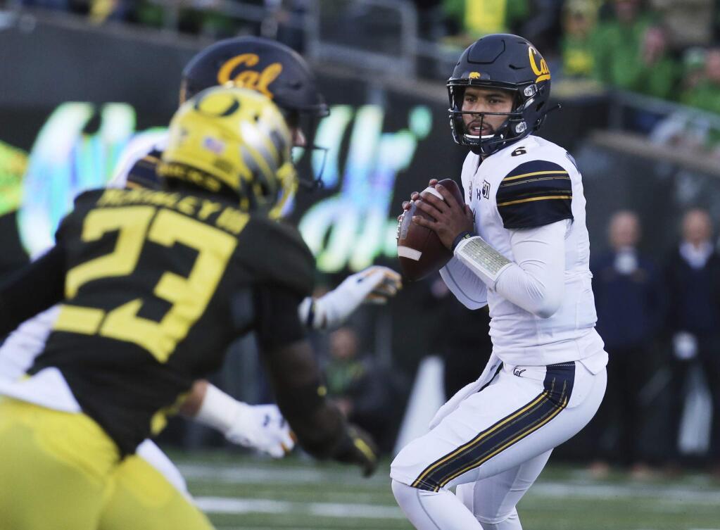 California quarterback Devon Modster, right, looks down field for an open receiver against Oregon during the first quarter of an NCAA college football game Saturday, Oct.. 5, 2019, in Eugene, Ore. (AP Photo/Chris Pietsch)