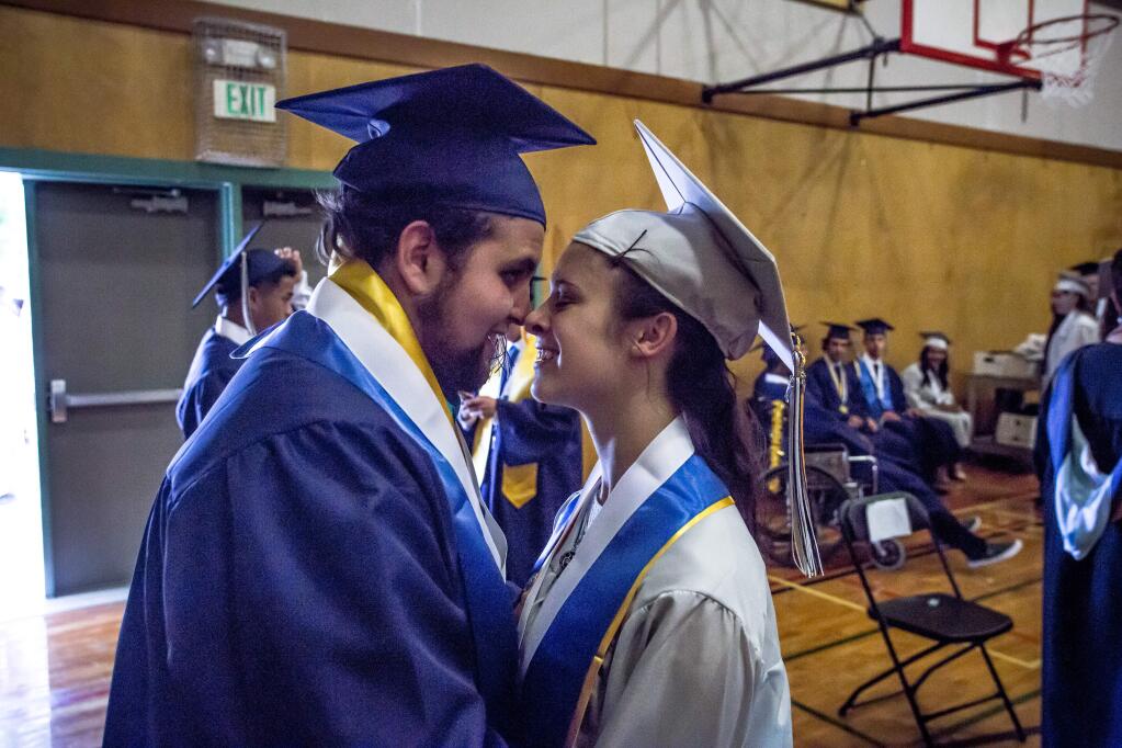 Martin Figueroa and Sierrastar Roberts catch a moment together before commencement ceremonies for Elsie Allen High School in Santa Rosa, Calif Friday, June 2, 2017.