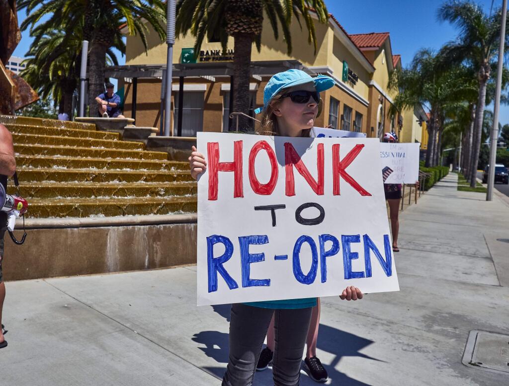 Protesters demonstrate against Gov. Newsom's shelter-in-place order April 24 in Santa Ana, California.