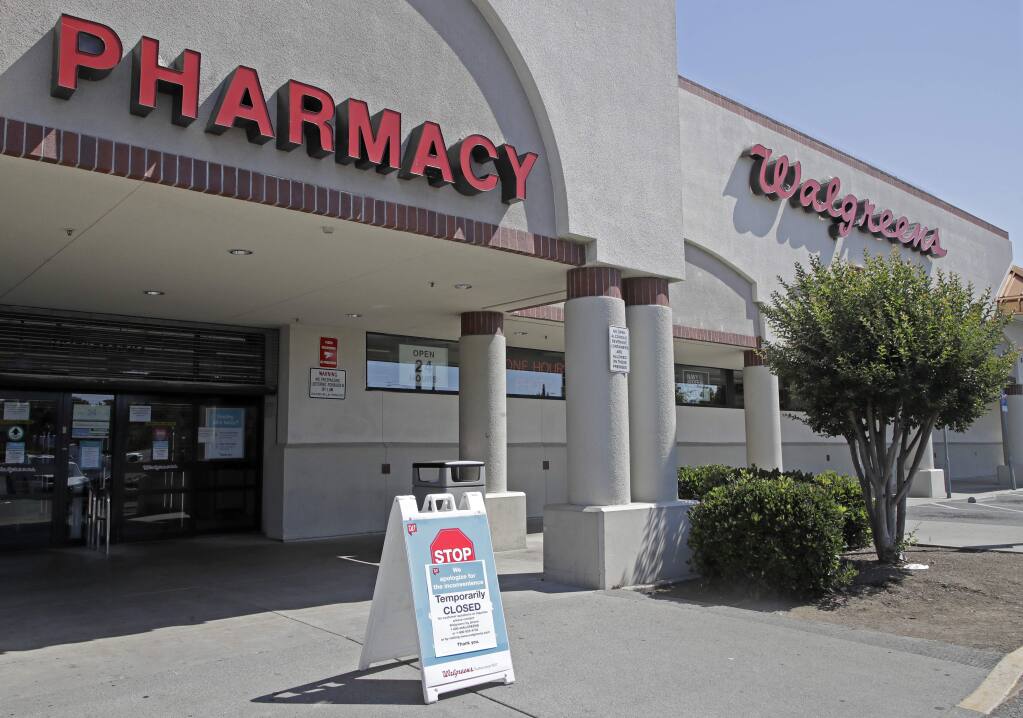 A sign alerting customers to a closed Walgreens store is seen on Wednesday, June 3, 2020, in Vallejo, Calif. A person was shot by police when people began breaking into stores late Monday, and another round of violence erupted late Tuesday, June 2, 2020.  (AP Photo/Ben Margot)