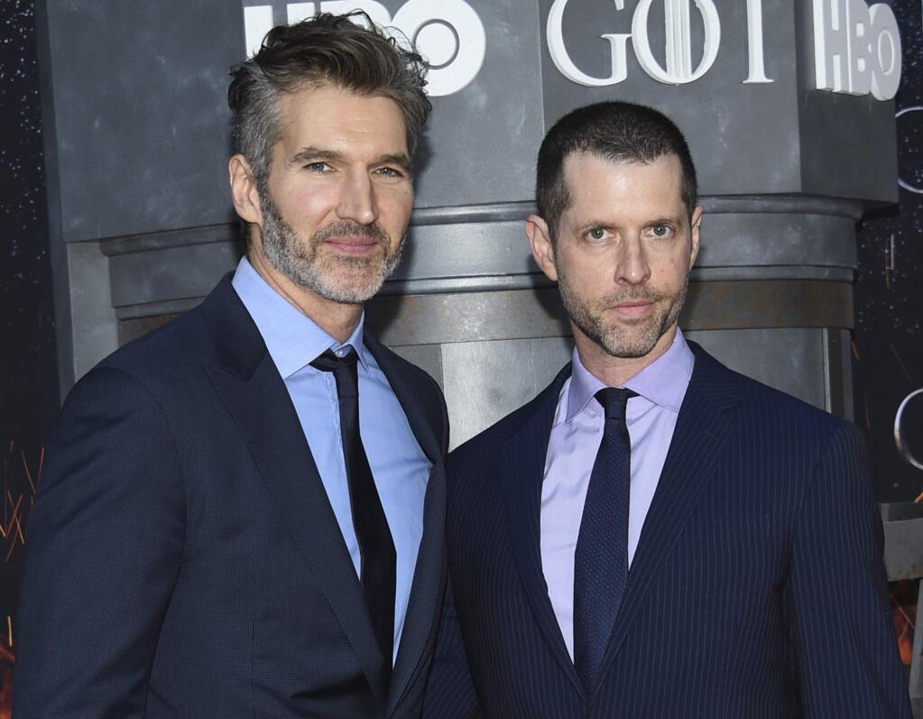 FILE - In this Wednesday, April 3, 2019, file photo, creator/executive producers David Benioff, left, and D. B. Weiss attend HBO's 'Game of Thrones' final season premiere at Radio City Music Hall in New York. Walt Disney Co. CEO Bob Iger said Tuesday, May 14, 2019, that ‚ÄúGame of Thrones‚Äù showrunners Benioff and Weiss are working on the new ‚ÄúStar Wars‚Äù film expected in theaters in December 2022. (Photo by Evan Agostini/Invision/AP, File)