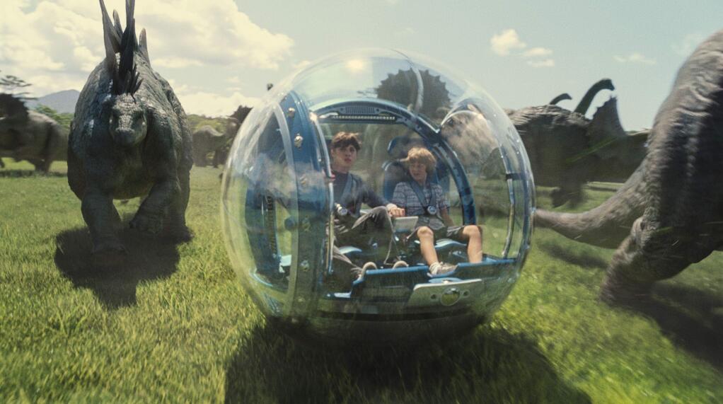 This photo provided by Universal Pictures shows, Nick Robinson, left, as Zach, and Ty Simpkins as Gray, in a scene from the film, 'Jurassic World,' directed by Colin Trevorrow, in the next installment of Steven Spielberg's groundbreaking 'Jurassic Park' series. The Universal Pictures 3D movie releases in theaters on June 12, 2015. (ILM/Universal Pictures/Amblin Entertainment via AP)