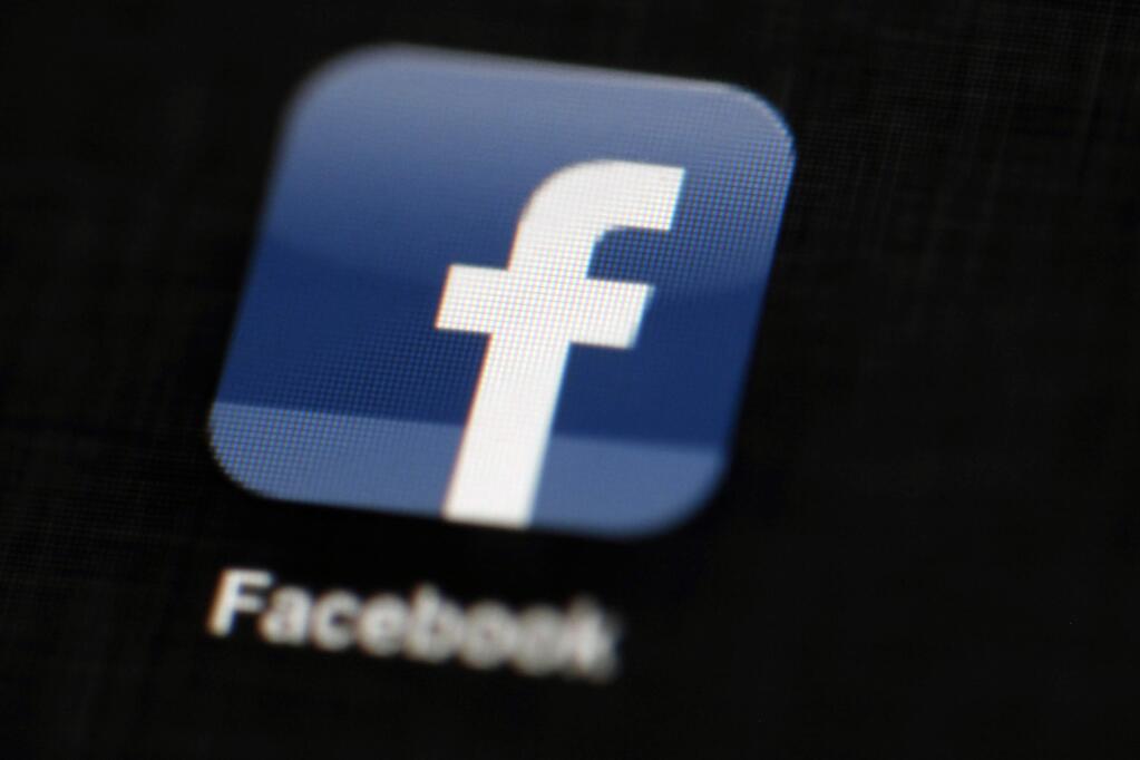 FILE - In this May 16, 2012, file photo, the Facebook logo is displayed on an iPad in Philadelphia. Facebook told The Associated Press on Aug. 16, 2017, it has banned the Facebook and Instagram accounts of one of a white nationalist who attended a rally in Charlottesville, Virginia, that ended in deadly violence. (AP Photo/Matt Rourke, File)