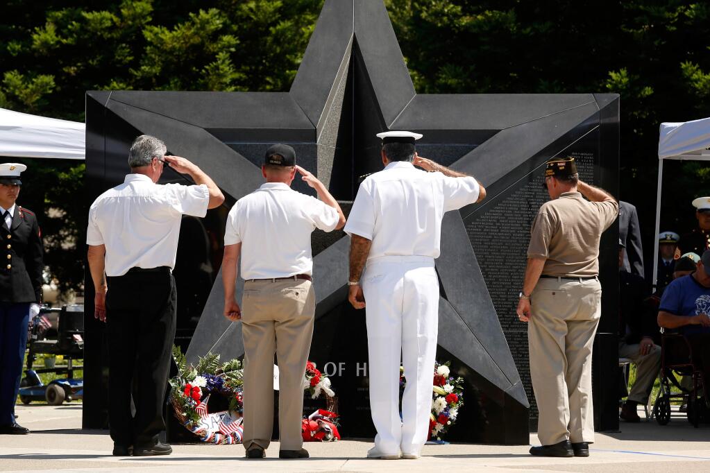 Sonoma Valley veterans Gary Magnani, Terry Leen, Bruce Janigian, and Bob Piazza salute after laying a wreath at the Star of Honor during the 58th annual Sonoma Valley Joint Memorial Day Observance at Sonoma Veterans Memorial Park in Sonoma, California on Monday, May 30, 2016. (Alvin Jornada / The Press Democrat)