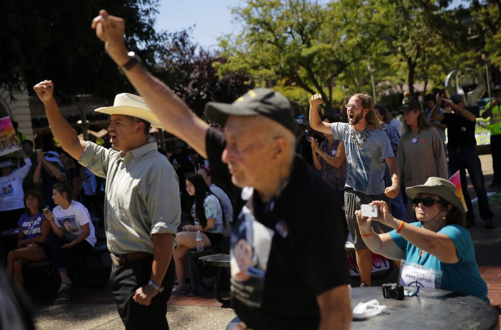 Demonstrators cheer on the speakers at a rally in Old Courthouse Square Saturday, July 12, 2014 to decry Sonoma County District Attorney Jill Ravitch's decision that Deputy Erick Gelhaus acted within the law when he shot and killed Andy Lopez (Conner Jay/The Press Democrat)