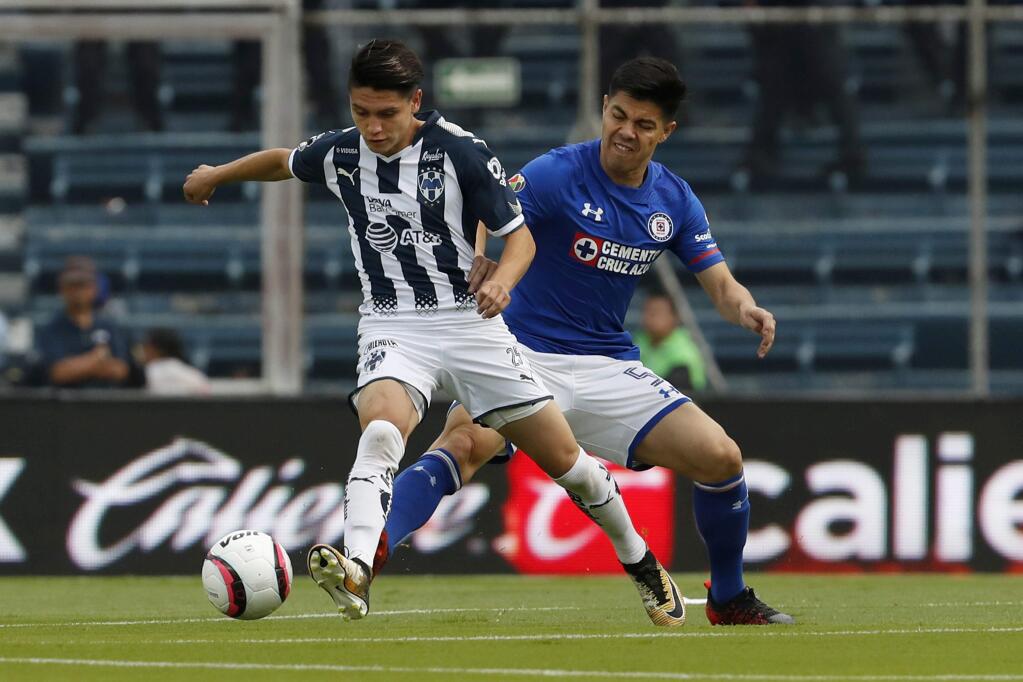 Monterrey's Jonathan Gonzalez, left, fights for the ball with Cruz Azul's Francisco Silva during a Mexico soccer league match in Mexico City, Saturday, Aug. 26, 2017. (AP Photo/Eduardo Verdugo)