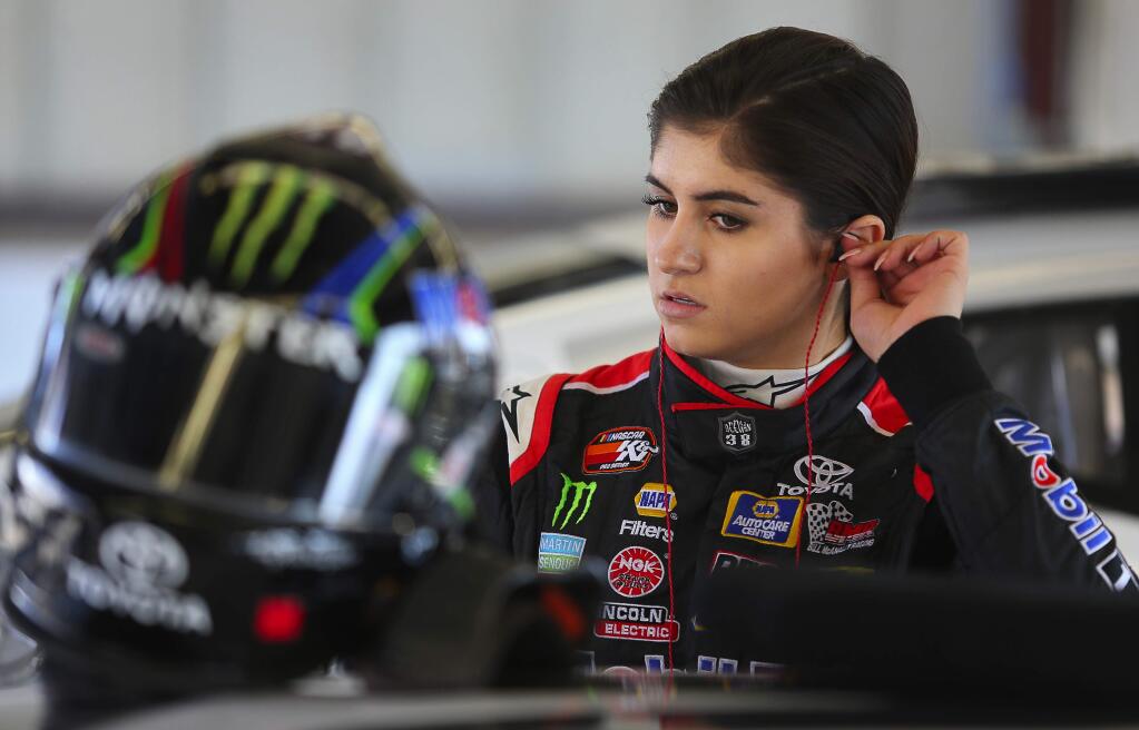 Hailie Deegan, 16, puts on her ear protection before practicing at Sonoma Raceway on Thursday, June 7, 2018. (Christopher Chung/ The Press Democrat)