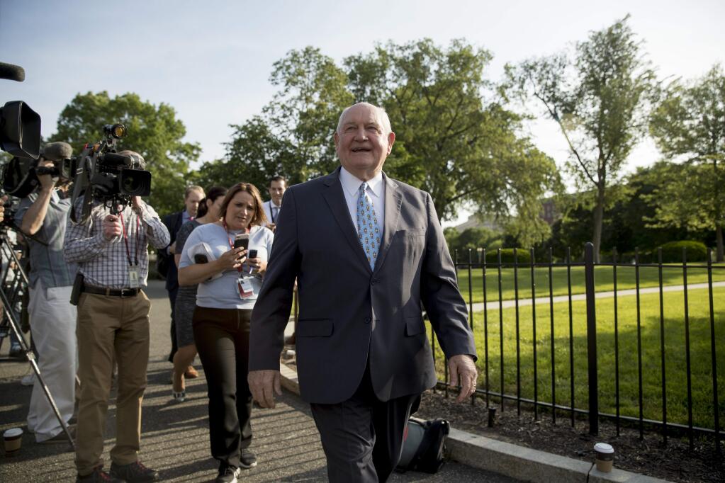 Agriculture Secretary Sonny Perdue laughs with a reporter on the North Lawn of the White House in Washington, Thursday, May 23, 2019.(AP Photo/Andrew Harnik)