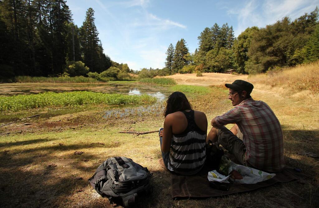 Chris Knight, right, and Sarahfina Bachrach enjoy a picnic at Bullfrog Pond in the Austin Creek State Recreation Area. (PD File, 2012)