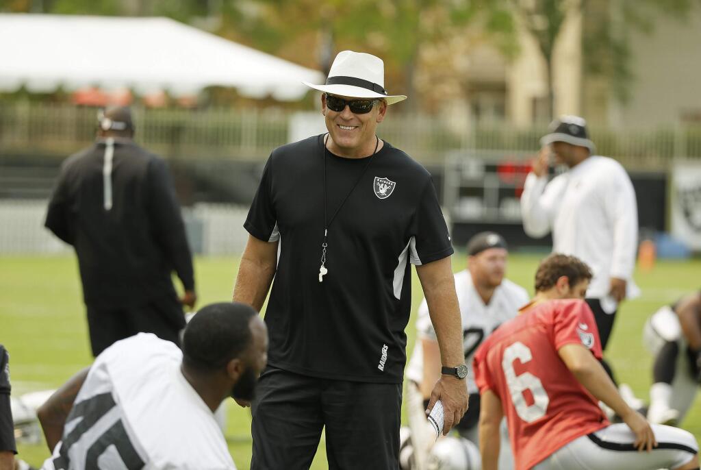 Oakland Raiders head coach Jack Del Rio watches players stretch during their NFL football training camp Friday, July 31, 2015, in Napa, Calif. (AP Photo/Eric Risberg)