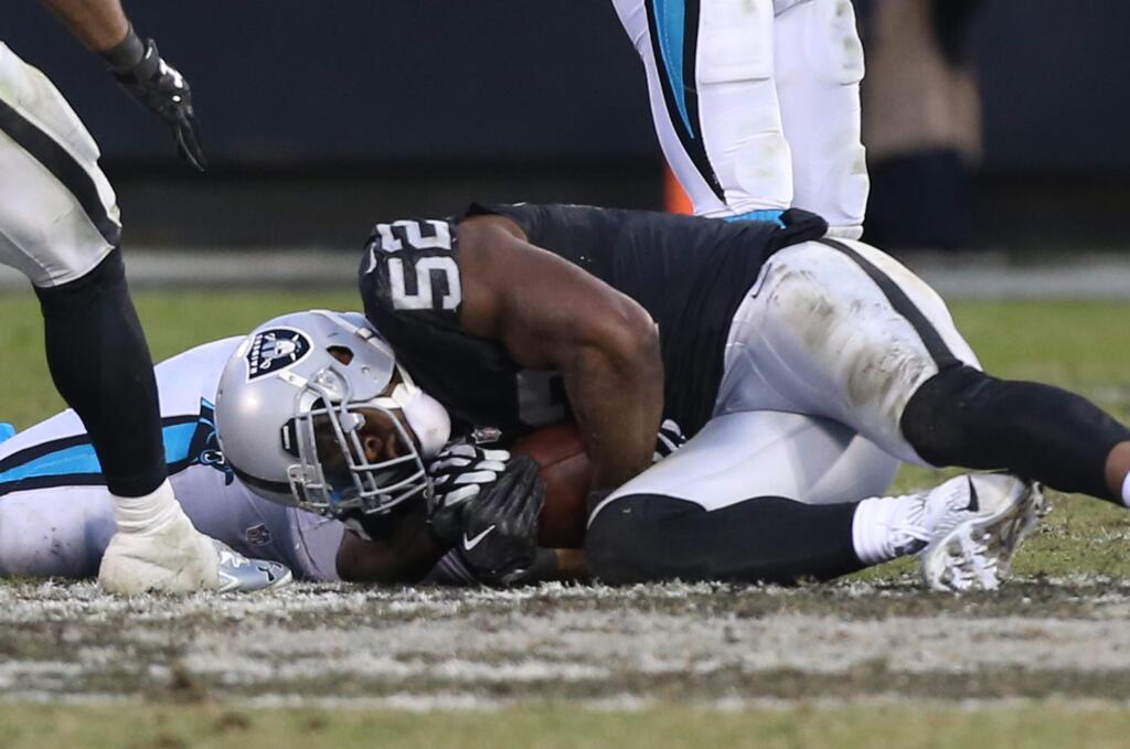 Oakland Raiders defensive end Khalil Mack recovers the fumble after stripping Carolina Panthers quarterback Cam Newton of the football during their game in Oakland on Sunday, November 27, 2016. The Raiders defeated the Panthers 35-32.(Christopher Chung/ The Press Democrat)