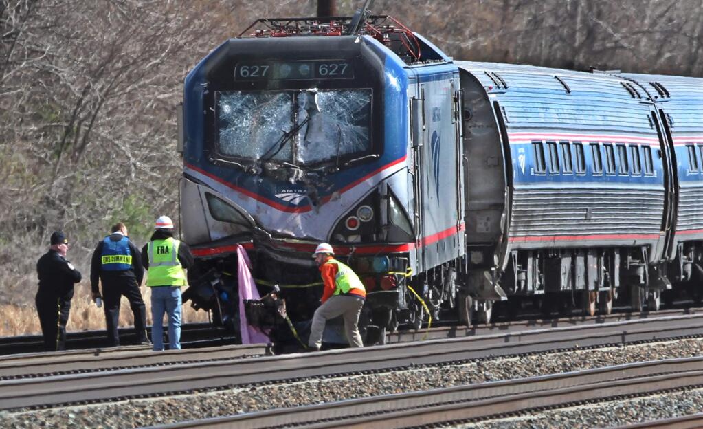Amtrak investigators inspect the deadly train crash in Chester, Pa., Sunday, April 3 2016. The Amtrak train struck a piece of construction equipment just south of Philadelphia causing a derailment. (Michael Bryant/The Philadelphia Inquirer via AP)