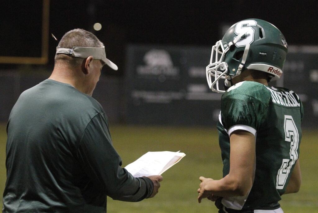 Bill Hoban/Index-TribuneSonoma Dragon coach Bob Midgley goes over a play with quarterback Guillermo Hurtado in a recent game.
