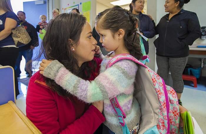 Maria Reyes comforts her daughter Allison Gonzalez, 5, as the students are asked to say goodbye to their parents before the start of kindergarten class. There was the usual combination of enthusiasm and tears on the first day of school at Sassarini Elementary, as schools throughout the valley threw open their doors to welcome students to a new year. (Photos by Robbi Pengelly/Index-Tribune)
