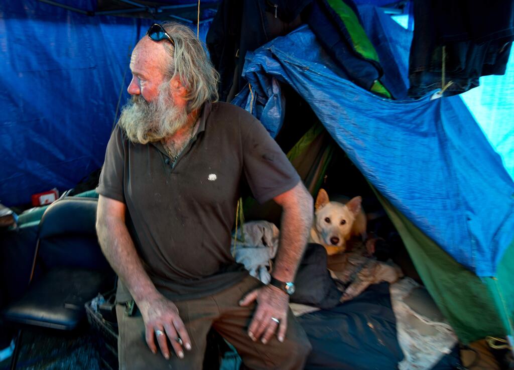 Preston Boswell and his dog Odie moved to the a homeless encampment behind the Dollar Tree store in Roseland last November when they were moved on from under the 6th Street bridge. (JOHN BURGESS/ PD)
