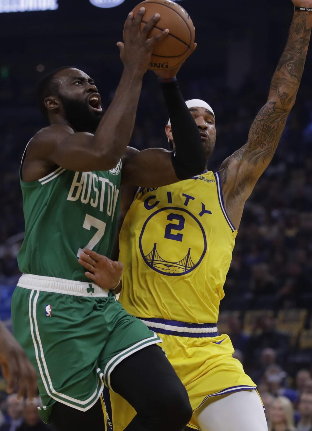 Boston Celtics' Jaylen Brown, left, shoots against Golden State Warriors' Willie Cauley-Stein (2) in the first half of an NBA basketball game Friday, Nov. 15, 2019, in San Francisco. (AP Photo/Ben Margot)