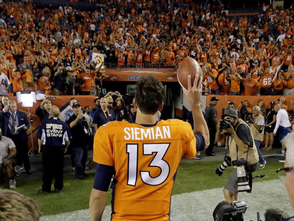 Denver Broncos quarterback Trevor Siemian (13) waves to fans as he leaves the field after an NFL football game against the Carolina Panthers, Thursday, Sept. 8, 2016, in Denver. The Broncos won 21-20. (AP Photo/Jack Dempsey)