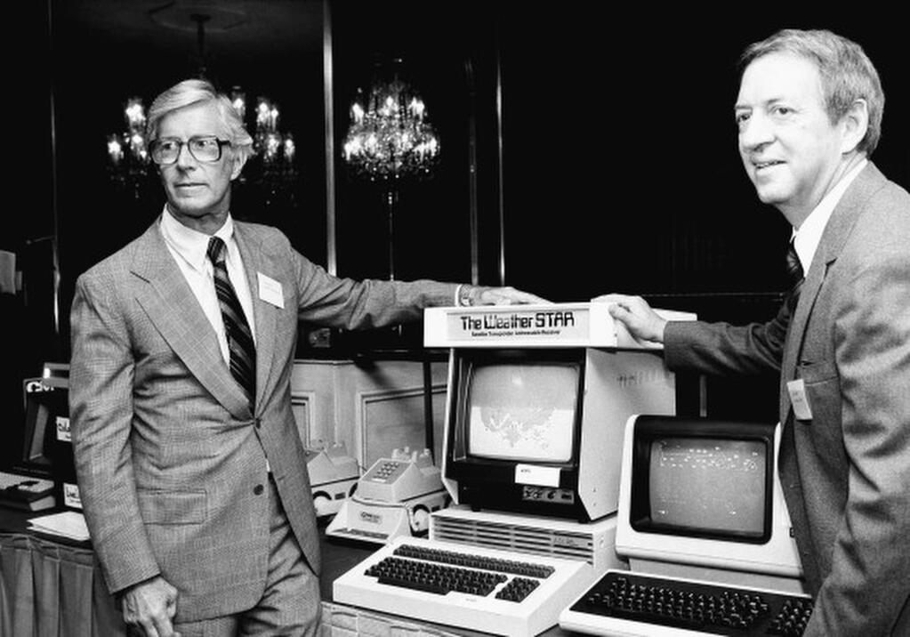 In this July 30, 1981 photo, John Coleman, weather channel founder, right, and Frank Batten, publisher of the Norfolk, Va., Virginian-Pilot and Ledger-Star, and chairman and chief executive of Landmark Communications, Inc., are seen during a news conference in New York. John Coleman, the founder of The Weather Channel and longtime KUSI weatherman, died Saturdaty night, Jan. 20, 2018, at home in Las Vegas, said his wife Linda Coleman. He was 83. (AP Photo/Marty Lederhandler, File)