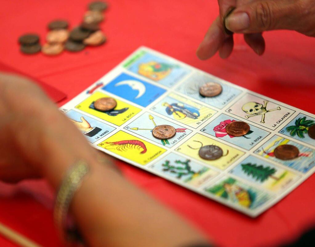 -A player marks off her card during a loteria game at the Windsor Senior Center earlier this month.
