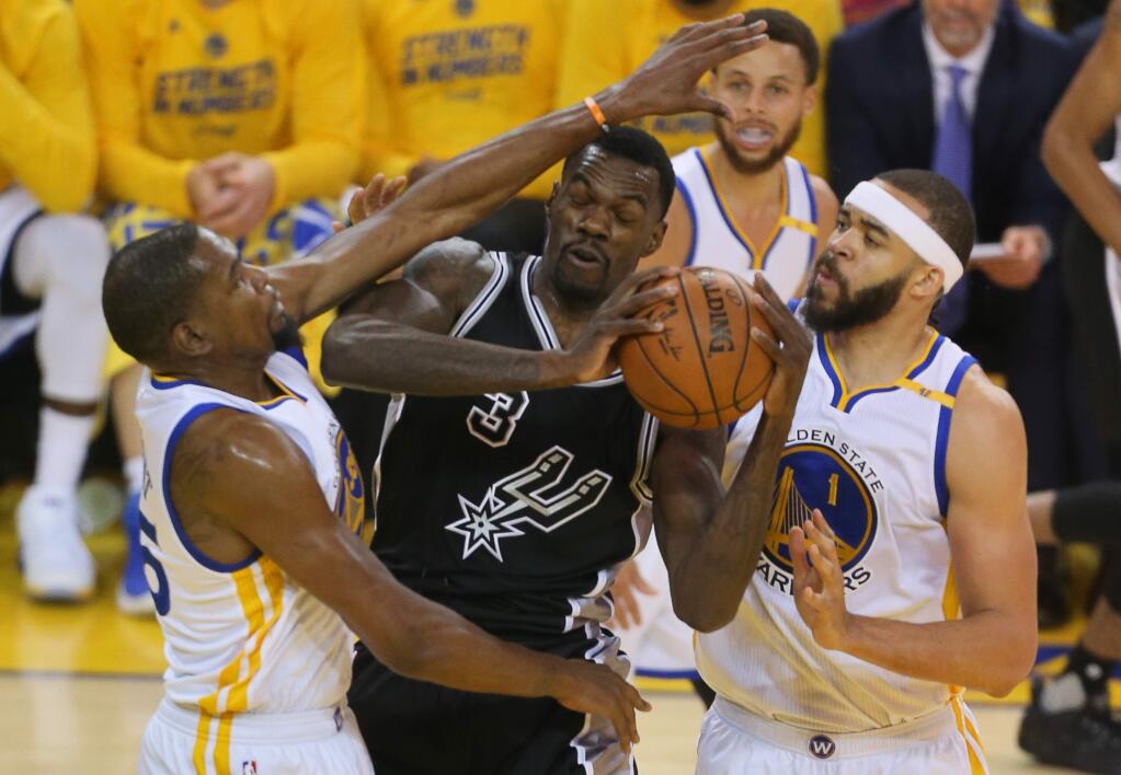 Golden State Warriors forward Kevin Durant and center JaVale McGee double-team San Antonio Spurs center Dewayne Dedmon during Game 2 of the NBA Western Conference Finals in Oakland on Tuesday, May 16, 2017. The Warriors defeated the Spurs 136-100. (Christopher Chung / The Press Democrat)