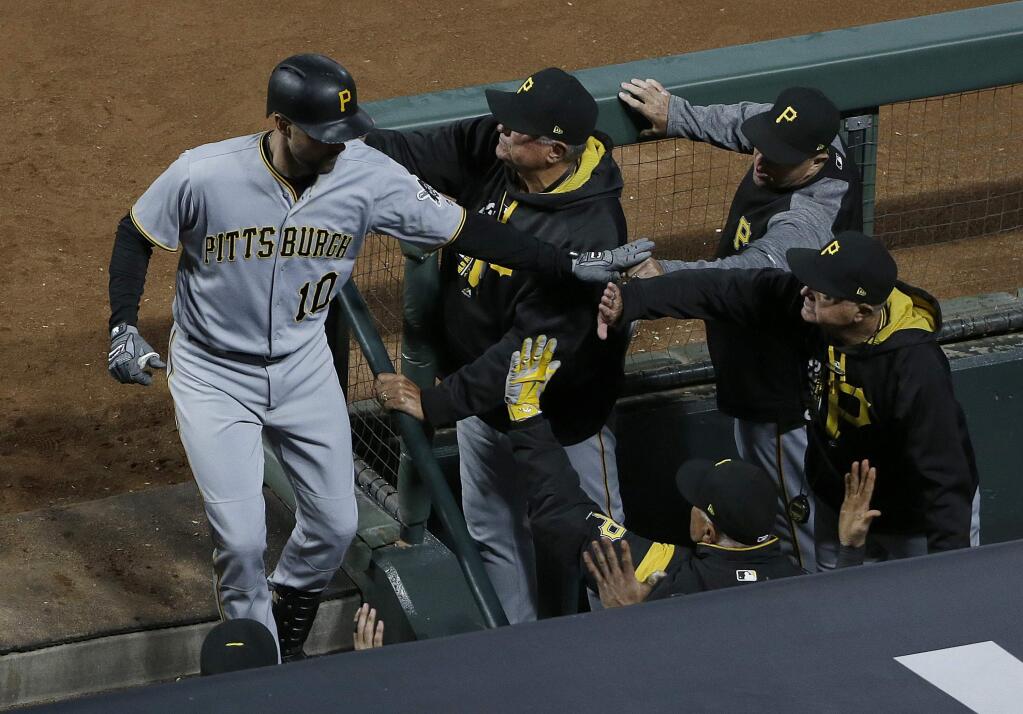 Pittsburgh Pirates' Jordy Mercer (10) is congratulated after hitting a three-run home run against the San Francisco Giants during the eighth inning of a baseball game in San Francisco, Monday, July 24, 2017. (AP Photo/Jeff Chiu)