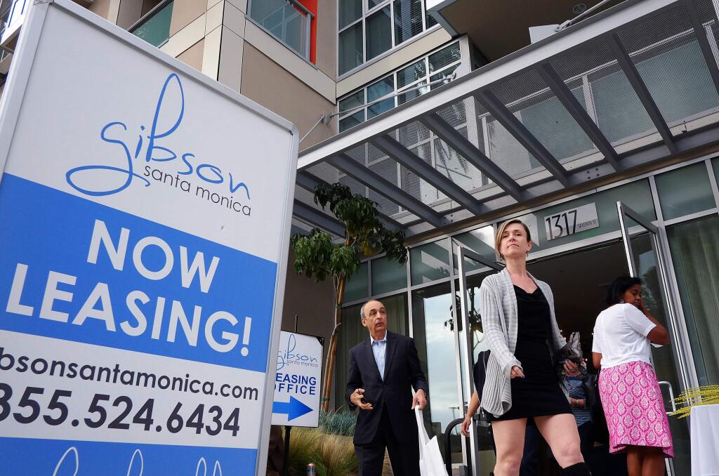In this Wednesday, March 18, 2015 photo, visitors arrive for the grand opening of Gibson Santa Monica, a new luxury apartment complex in downtown Santa Monica, Calif. Residential rents, the biggest driver of inflation in 2015, climbed 3.5 percent in June from a year earlier, the fifth straight month with an annual gain of that size. (AP Photo/Richard Vogel)