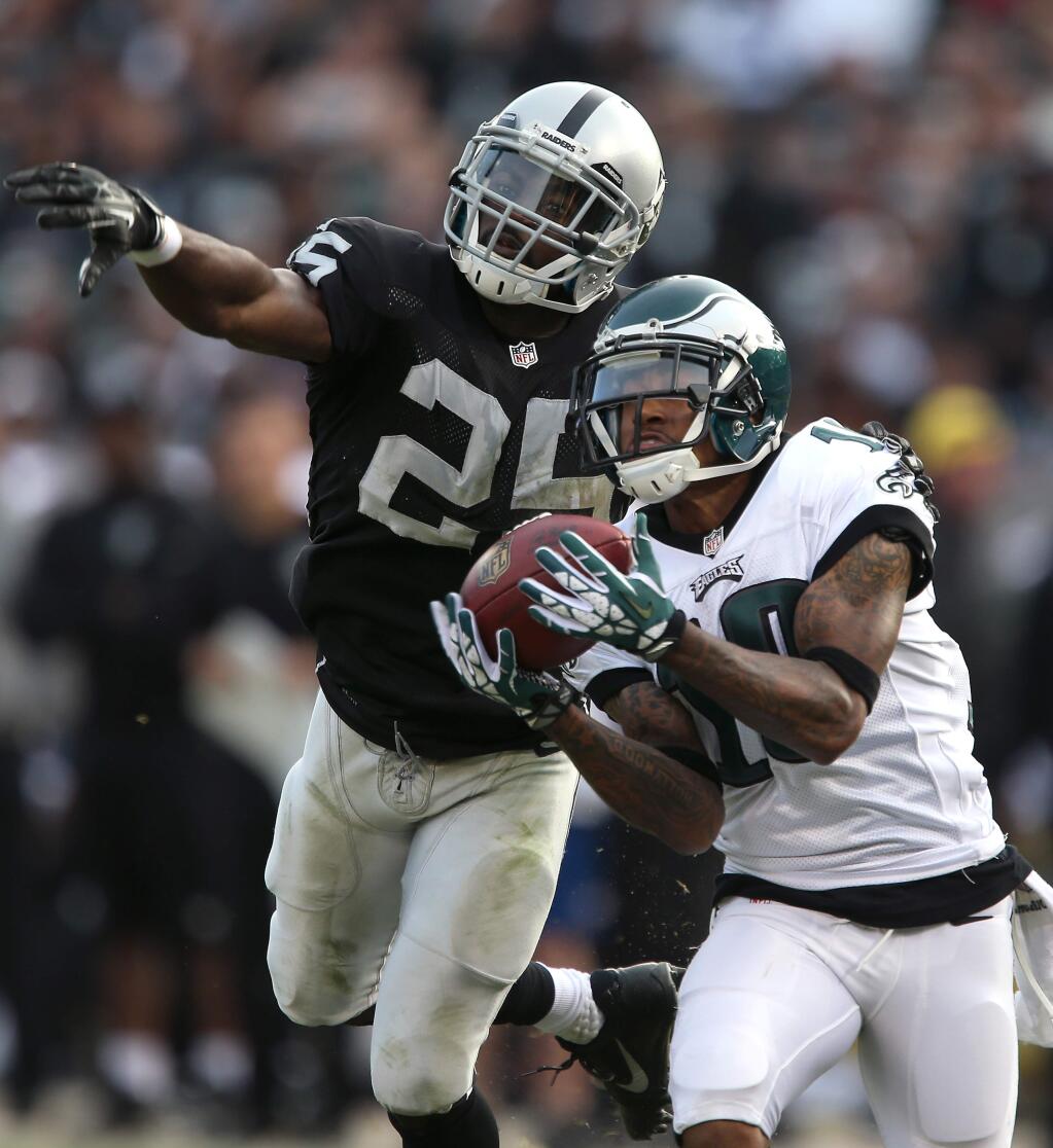 Philadelphia Eagles wide receiver DeSean Jackson pulls in a 59-yard pass while covered by Oakland Raiders cornerback DJ Hayden during the third quarter in Oakland on Sunday, Nov.3, 2013. The Eagles defeated the Raiders 49-20. (Christopher Chung / The Press Democrat)