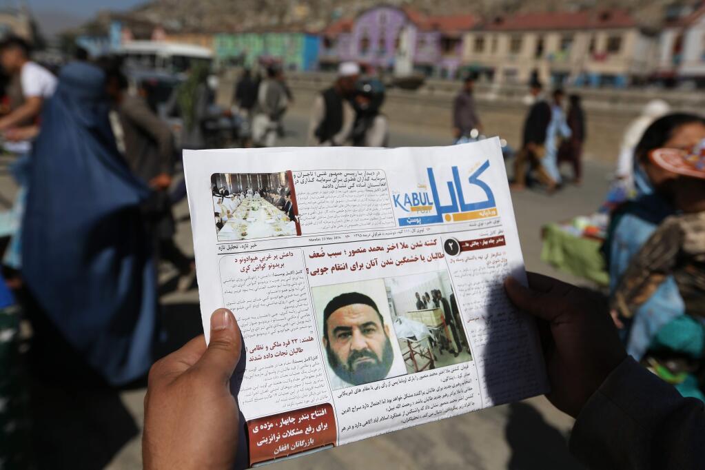 An Afghan man reads a local newspaper with photos the former leader of the Afghan Taliban, Mullah Akhtar Mansoor, who was killed in a U.S. drone strike last week, in Kabul, Afghanistan, Wednesday, May 25, 2016. The Afghan Taliban has confirmed that its former leader Mullah Akhtar Mansour was killed in a U.S. drone strike last week and appointed a successor. In a statement sent to media Wednesday, May 25, 2016, the insurgent group said its new leader is Mullah Haibatullah Akhundzada, one of two Mansour's deputies. (AP Photo/Rahmat Gul)