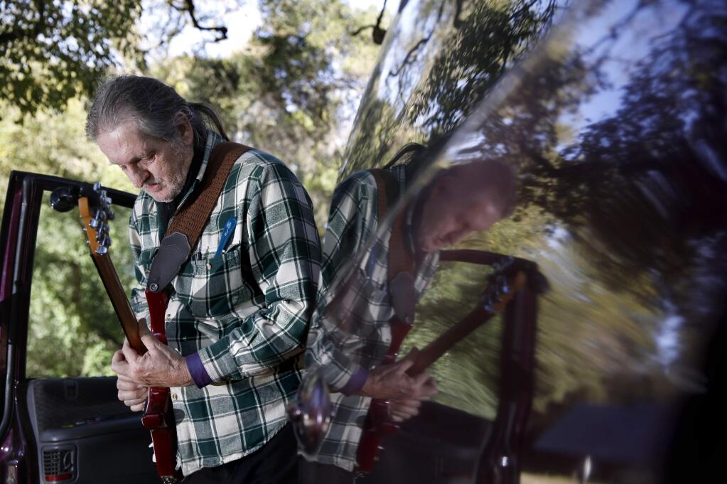 Stephen 'Song' Sheridan, who plays his guitar out of a van that he calls home, is owed $50 by the state. Photo taken at Doyle Park on Sunday, February 15, 2015 in Santa Rosa, California . (BETH SCHLANKER/ The Press Democrat)