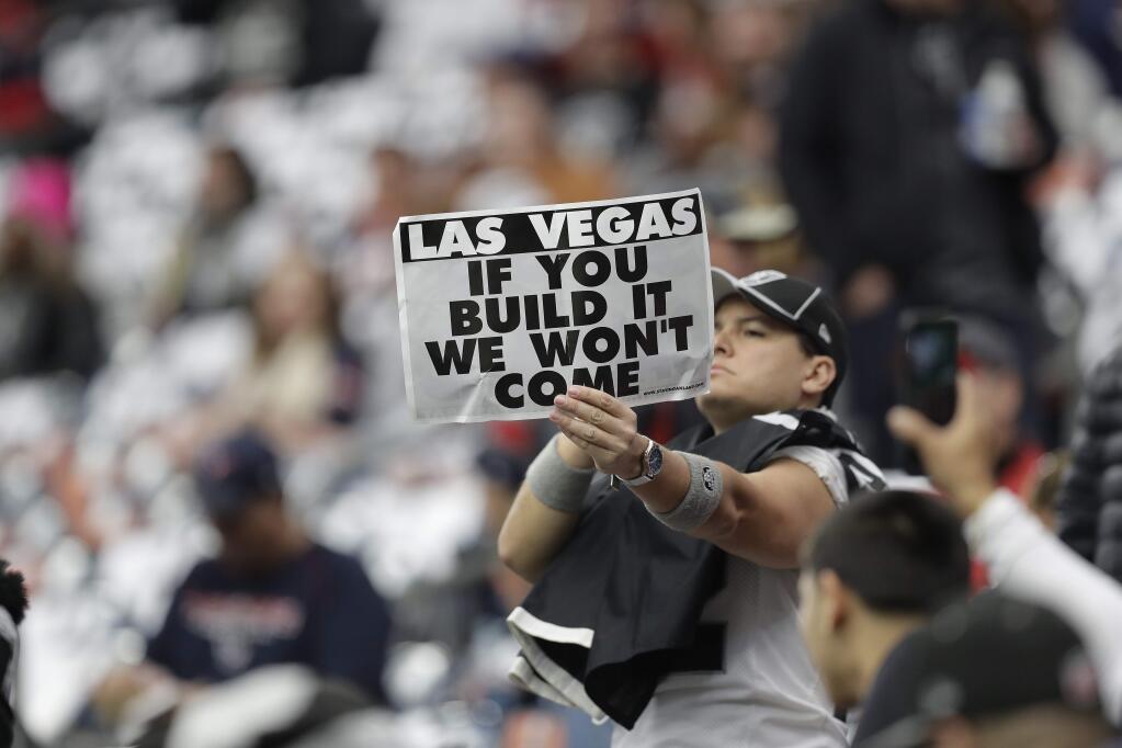 A Oakland Raiders fan holds a sign before the first half of Saturday's wild-card game between the Houston Texans and the Oakland Raiders, Saturday, Jan. 7, 2017, in Houston. (AP Photo/Eric Gay)