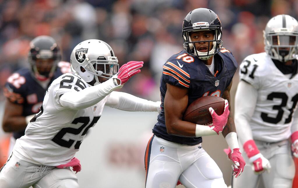Chicago Bears wide receiver Marquess Wilson (10) runs away from Oakland Raiders cornerback D.J. Hayden (25) during a game in Chicago, Sunday, Oct. 4, 2015. The Bears won 22-20. (Rick West/Daily Herald via AP)