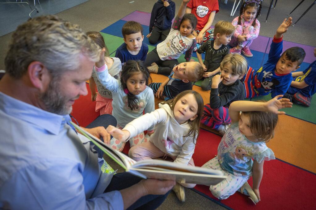 Byron Sebastian reads to kindergarteners at Healdsburg Elementary School on Thursday. The school board voted to combine the Charter and Elementary school kindergartens this year and then integrate the other grades next year. (John Burgess/The Press Democrat)