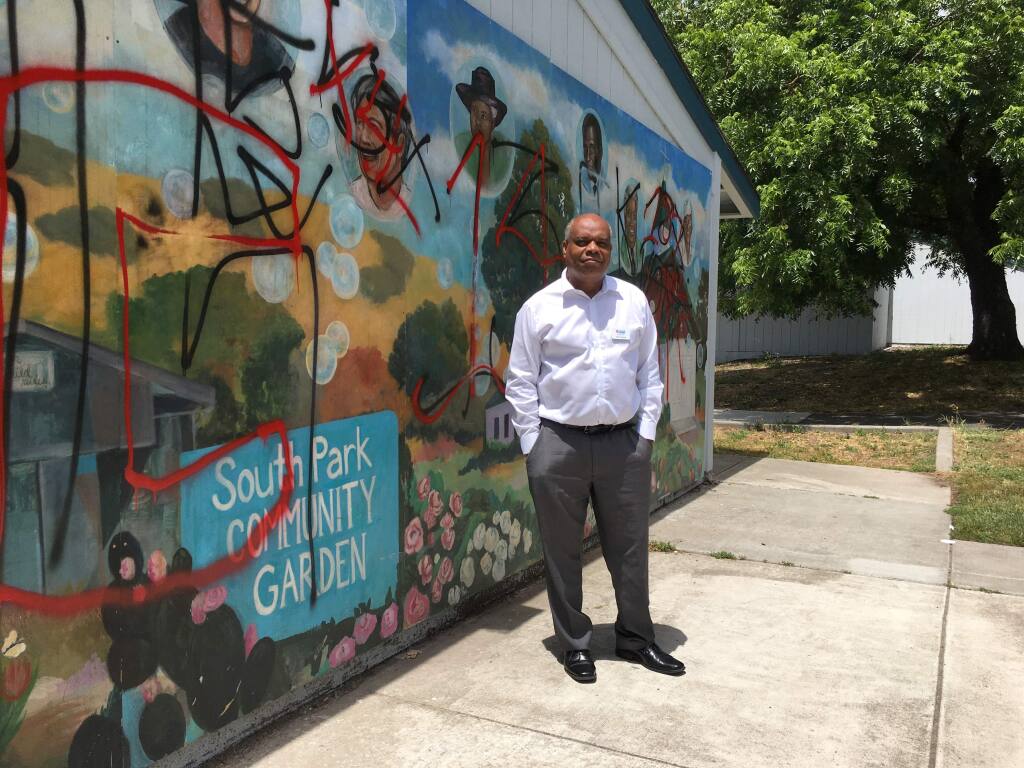 Vince Harper, assistant director of community engagement for Community Action Partnership, in front of the Santa Rosa mural.