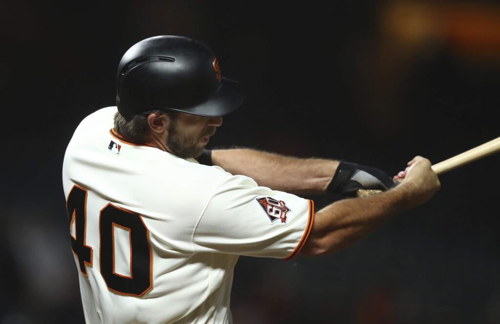 San Francisco Giants' Madison Bumgarner swings for the game winning hit against the San Diego Padres in the 12th inning of a baseball game Tuesday, Sept. 25, 2018, in San Francisco. (AP Photo/Ben Margot)