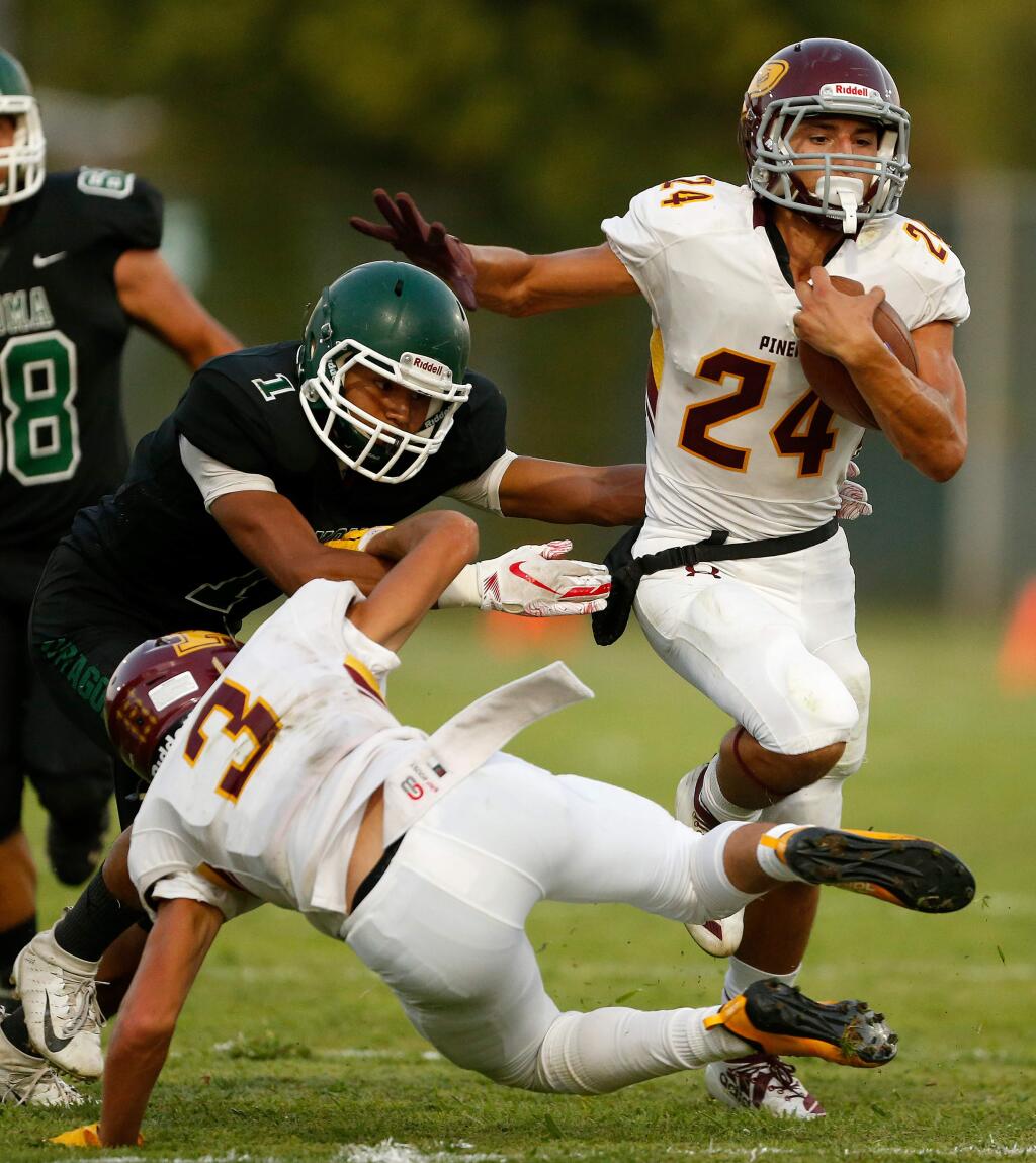 Piner's Adrian Torres, right, evades Sonoma Valley's Jose Garcia while carrying the ball for a gain on Friday, Sept. 13, 2019. (Alvin Jornada / The Press Democrat)