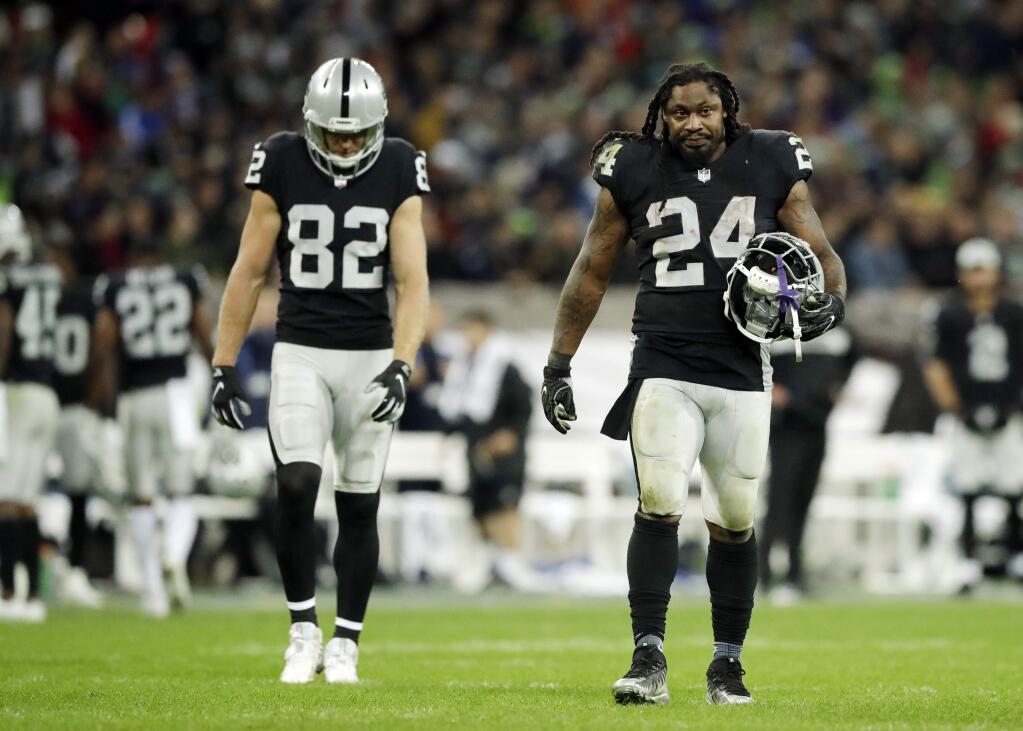 Oakland Raiders running back Marshawn Lynch, right, and wide receiver Jordy Nelson walk off the field during the second half at Wembley stadium in London, Sunday, Oct. 14, 2018. (AP Photo/Matt Dunham)