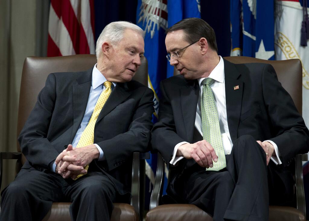 Attorney General Jeff Sessions speaks with Deputy Attorney General Rod Rosenstein, during the opening of the summit on Efforts to Combat Human Trafficking at Department of Justice in Washington, Friday, Feb. 2, 2018. President Donald Trump, dogged by an unrelenting investigation into his campaign's ties to Russia, lashes out at the FBI and Justice Department as politically biased ahead of the expected release of a classified Republican memo criticizing FBI surveillance tactics. (AP Photo/Jose Luis Magana)