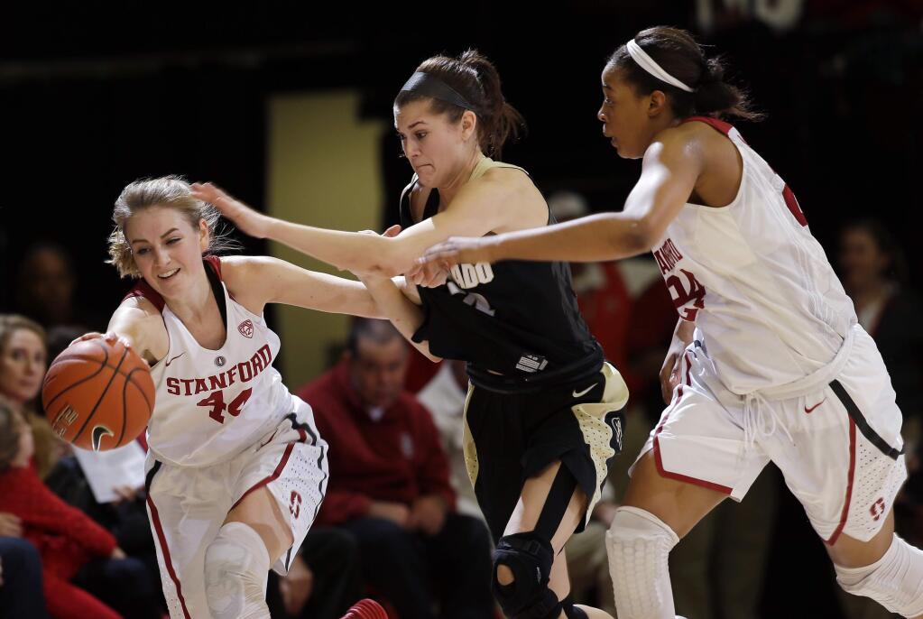 Stanford guard Karlie Samuelson, left, battles for a loose ball against Colorado's Lauren Huggins, center, during a game in January. (AP Photo/Marcio Jose Sanchez)