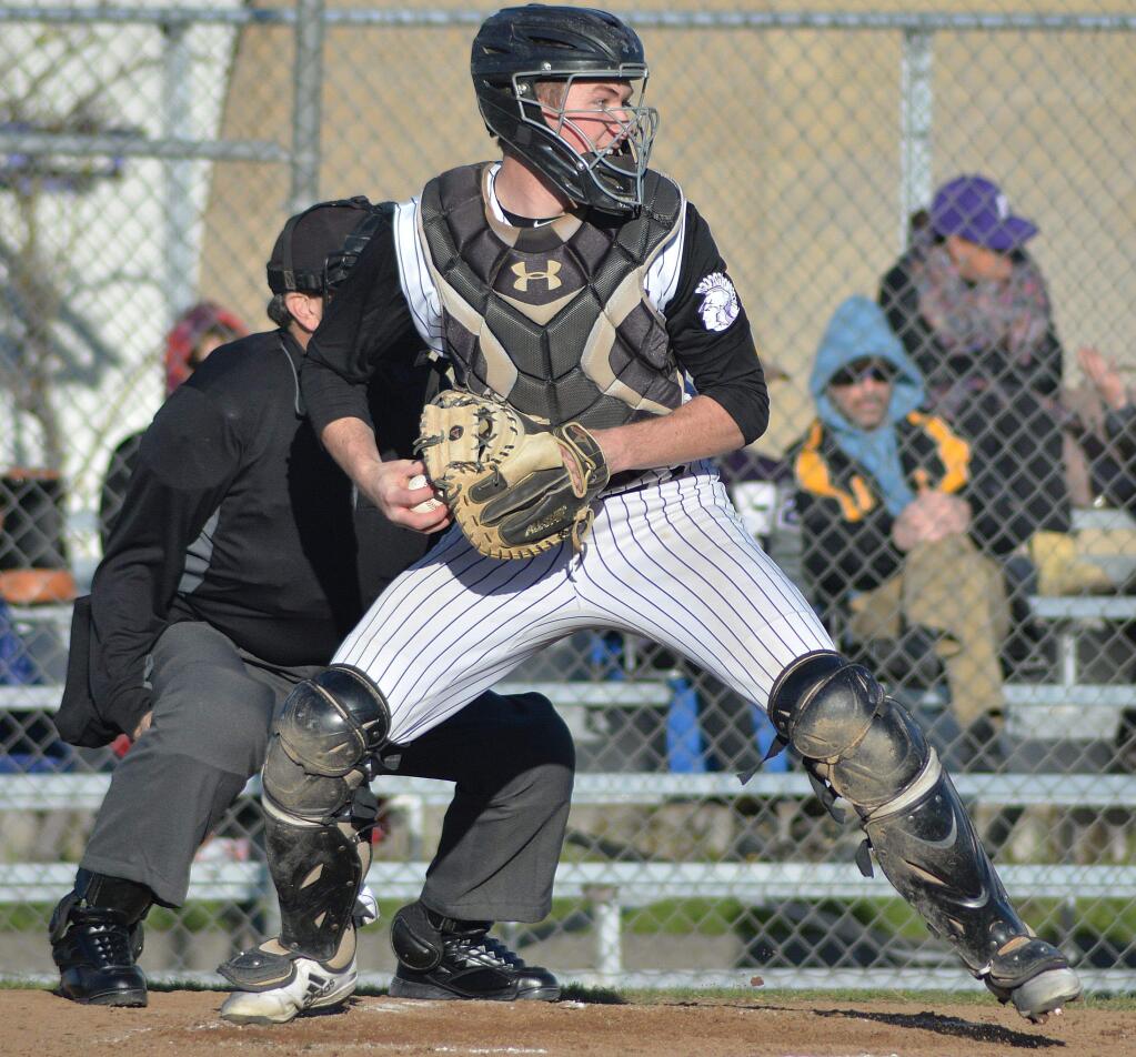 SUMNER FOWLER/FOR THE ARGUS-COURIERPetaluma High catcher Jack Gallagher prepares to make a thorw in the Trojans game against Drake. Gallagher had two hits, threw a would-be base stealer out and nailed another in a botched squeeze, but Petaluma lost, 3-0.
